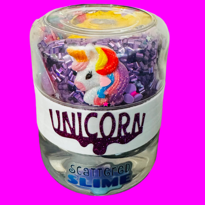 Jar of unicorn-themed slime with a colorful unicorn figure on a plain background
