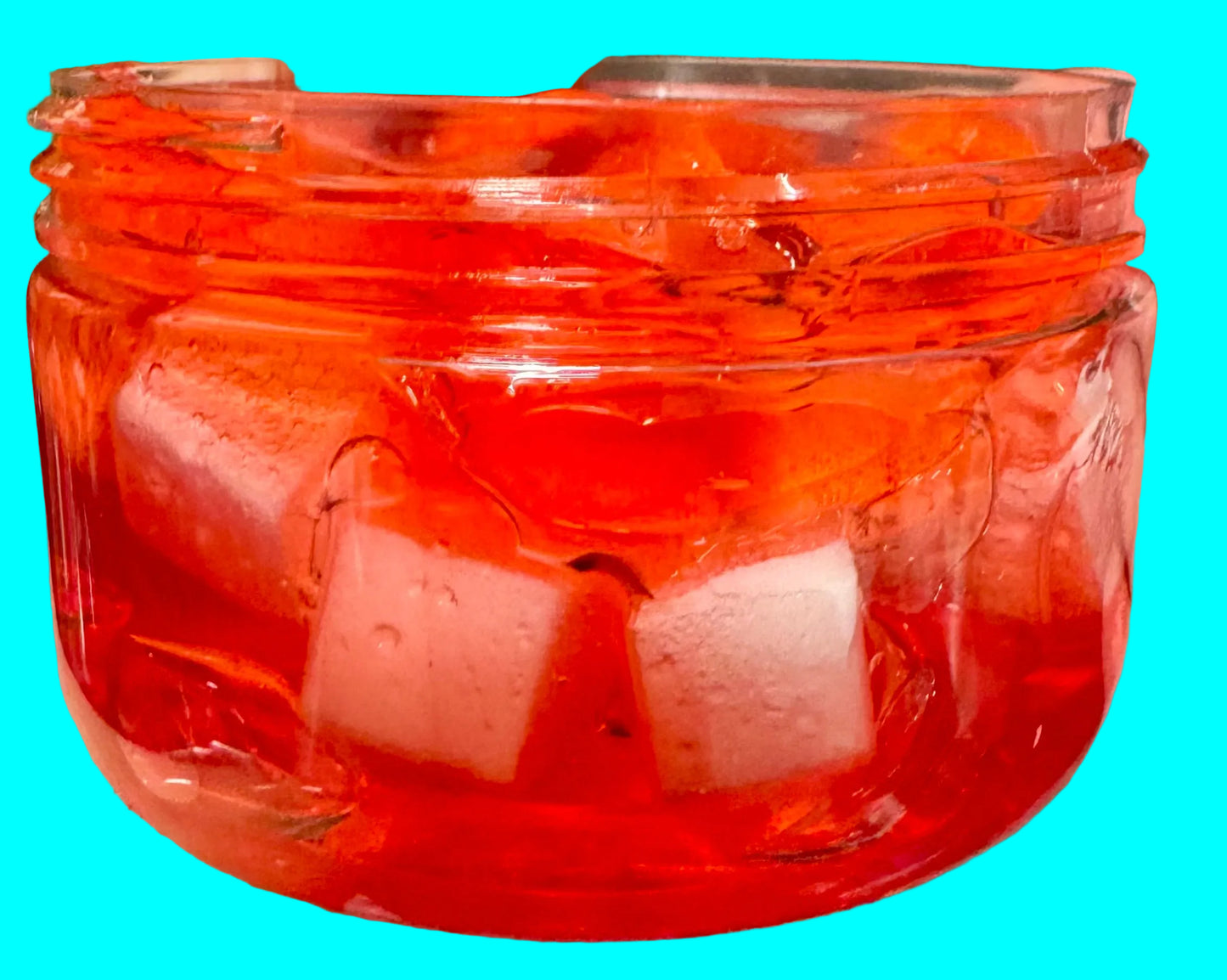 Clear container with red goo and white cubes
