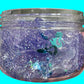 Clear container filled with purple and blue glittery slime