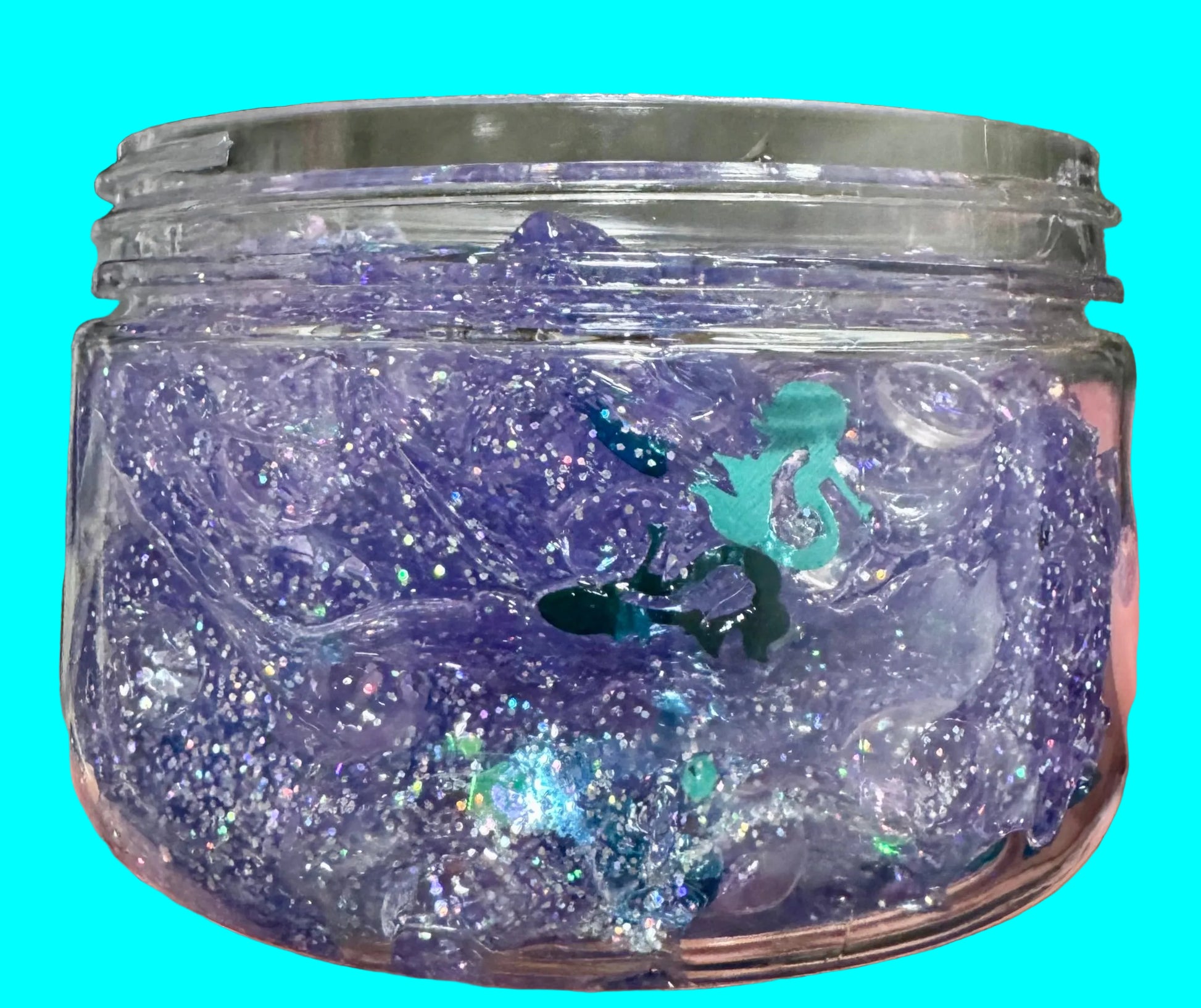 Clear container filled with purple and blue glittery slime