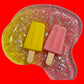Gelatinous dessert with a popsicle-shaped candy on a white plate