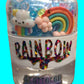 Jar of rainbow-themed slime with a cute cloud and rainbow figure on a blurred background